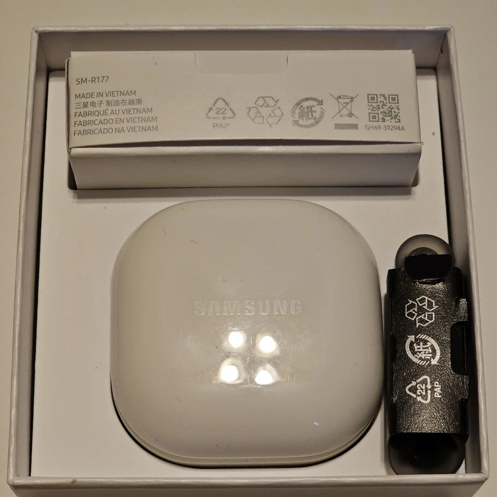 Samsung Galaxy Buds2, black in a white case.